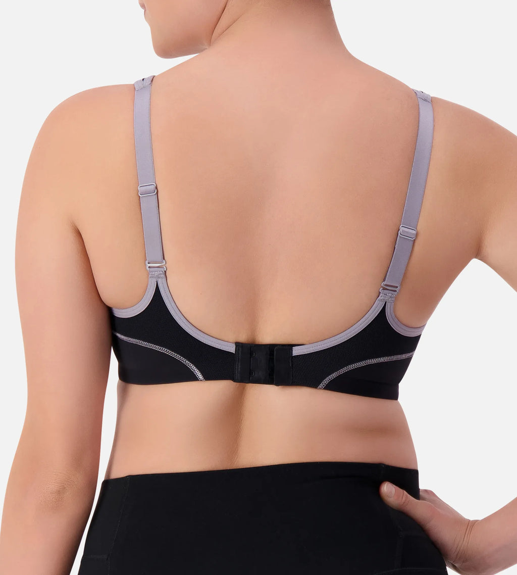 Black Triaction underwire sports bra by Triumph, showing supportive design and adjustable straps on a plain background.
