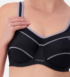 Black Triumph Triaction underwire sports bra with supportive design and adjustable straps, ideal for active wear.
