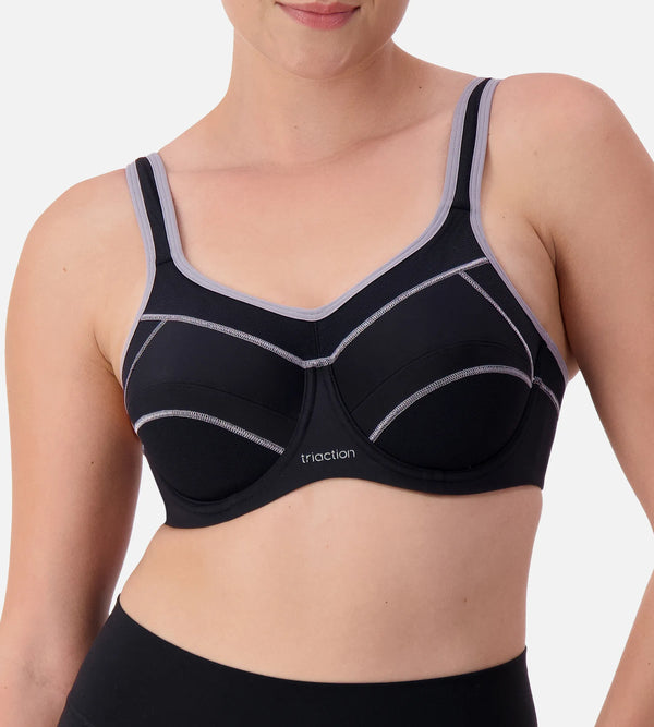 Black Triaction underwire sports bra by Triumph with supportive underwire and adjustable straps for active wear.