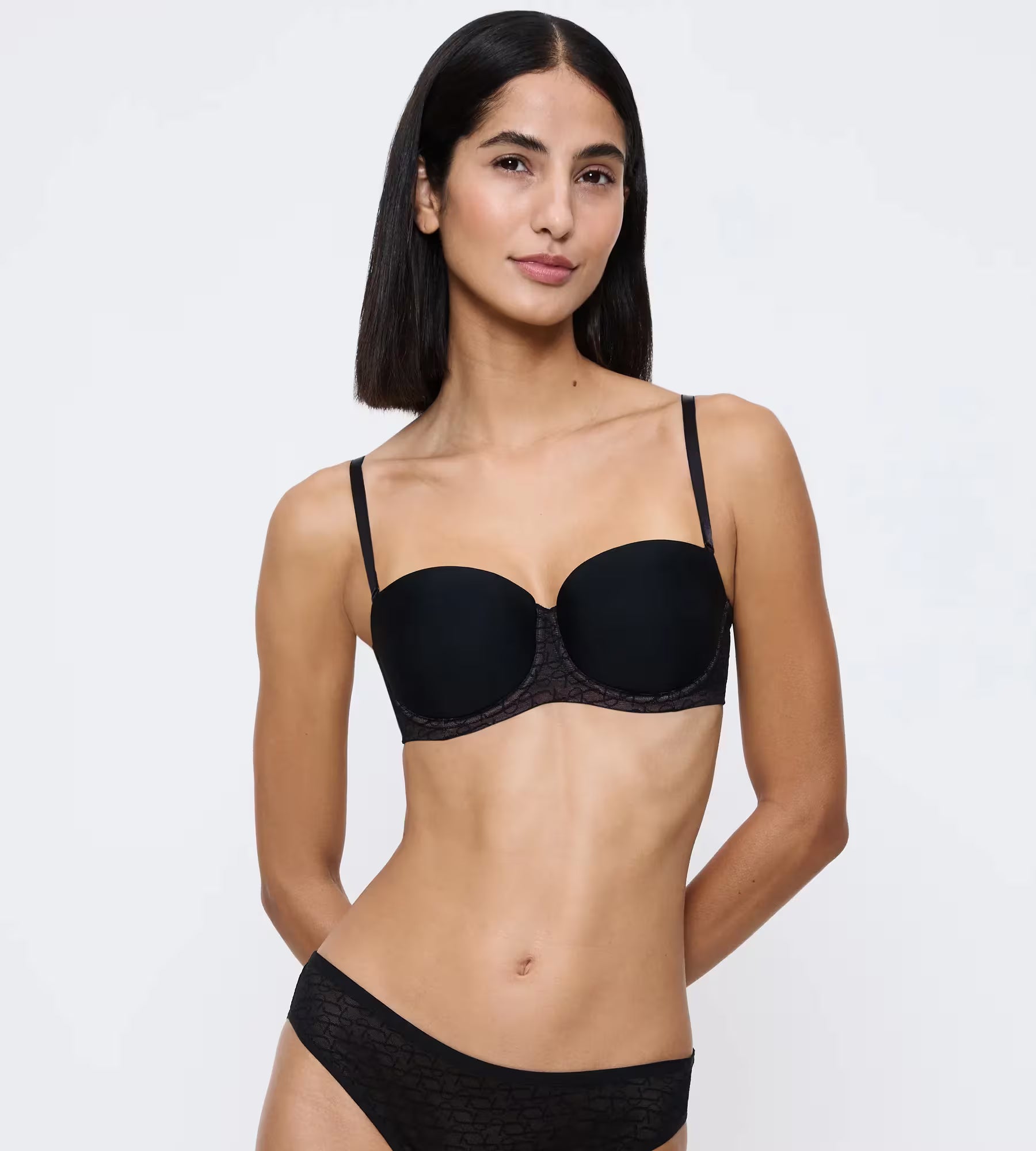 Triumph Signature Sheer Strapless bra shown on a model, featuring a delicate sheer design and supportive strapless fit.