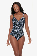 MIRACLESUIT Siren One Piece swimwear in Adorn, featuring a stylish design with vibrant blue and black colors on a model.