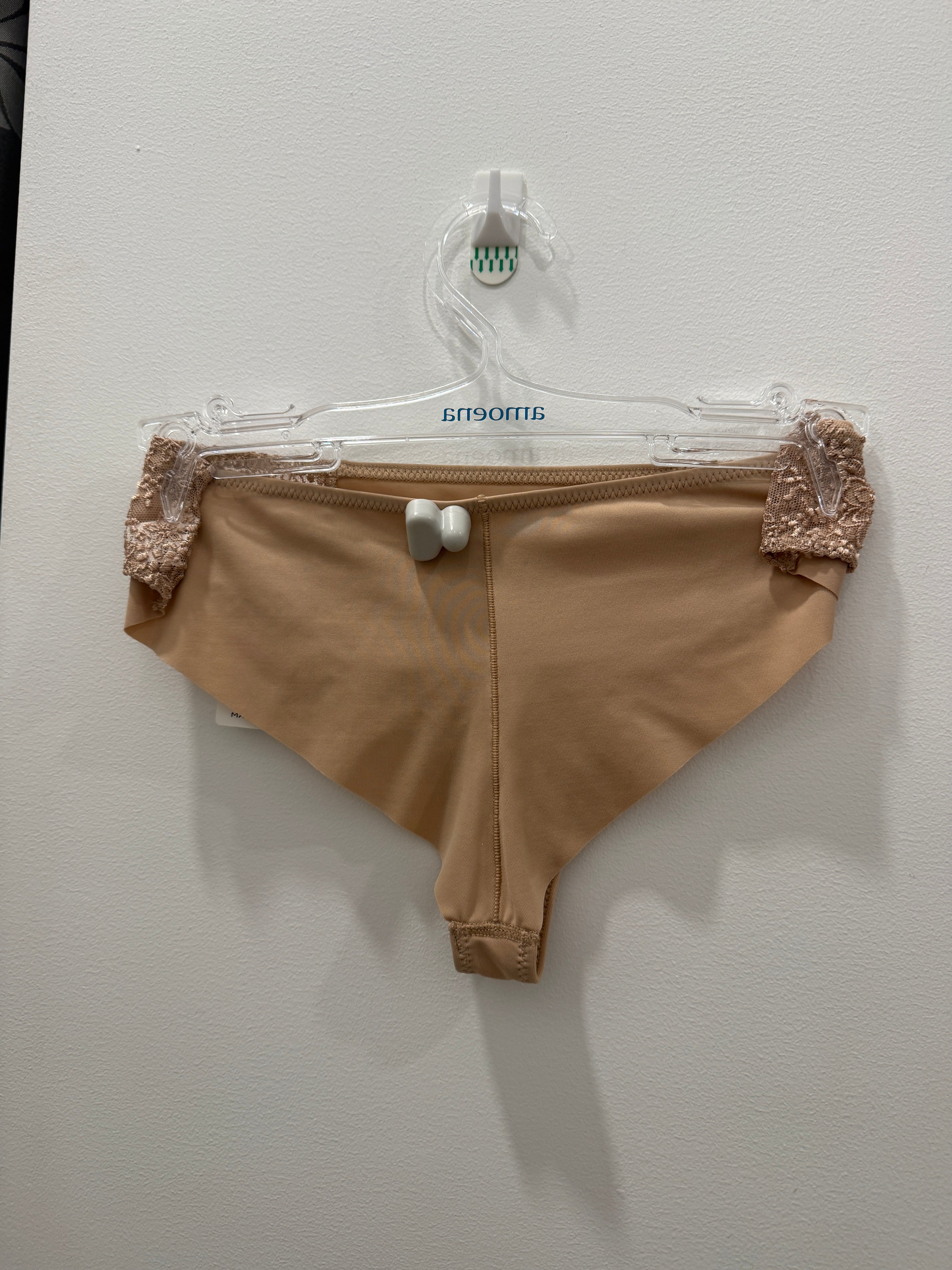 Beige GISELE G-string underwear by CORIN, featuring minimal coverage and delicate fabric for a comfortable fit.