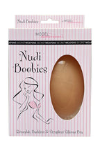 Nudi Boobies nude accessory from SECRET WEAPONS, showcasing a natural-toned decorative item for fashion or costume use.