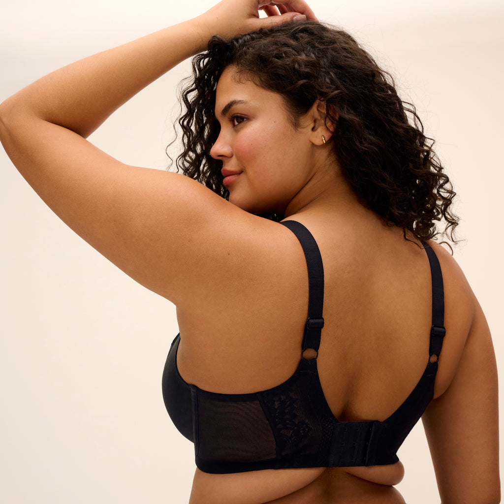 Black Nerina Uw Plunge Bra by Elomi, featuring stretch fabric, with smooth cups and adjustable straps for a comfortable fit.