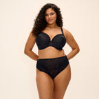 Black Nerina underwire plunge bra by Elomi with stretch fabric, shown on a model, featuring smooth cups and supportive design.