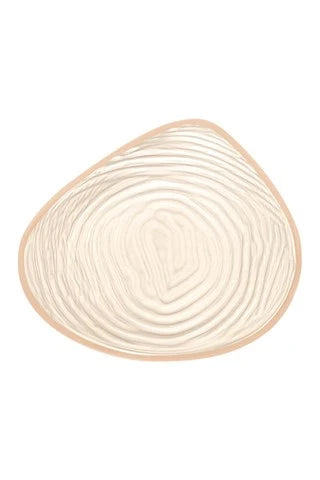 Left Natura Cosmetic 3E breast form from Amoea Mastectomy Range, showing the back view with realistic skin tone and shape.