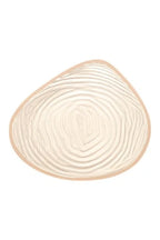 Left Natura Cosmetic 3E breast form from Amoea Mastectomy Range, showing the back view with realistic skin tone and shape.