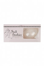 Clear Nudi Boobies accessory by SECRET WEAPONS, featuring transparent adhesive cups for discreet breast enhancement.