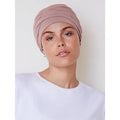 Zoya wearing a stylish HocEmmy V turban hat by HOUSE OF CHRISTINE, crafted from soft fabric in a vibrant color.