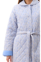 Givoni Allegra quilted cotton dressing gown in blue with long sleeves, available in size M, shown hanging or worn.
