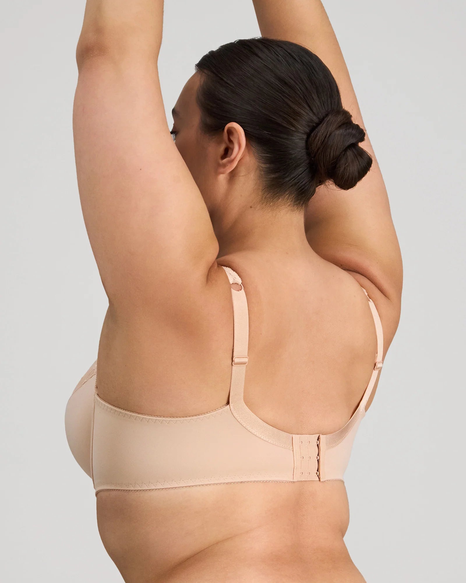 Coral underwire bra by FAYREFORM featuring floral lace embroidery and supportive design.