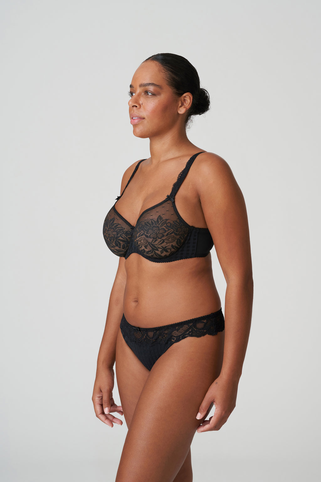 Black Primadonna Madison G-String underwear with delicate lace details and minimal coverage, shown on a white background.