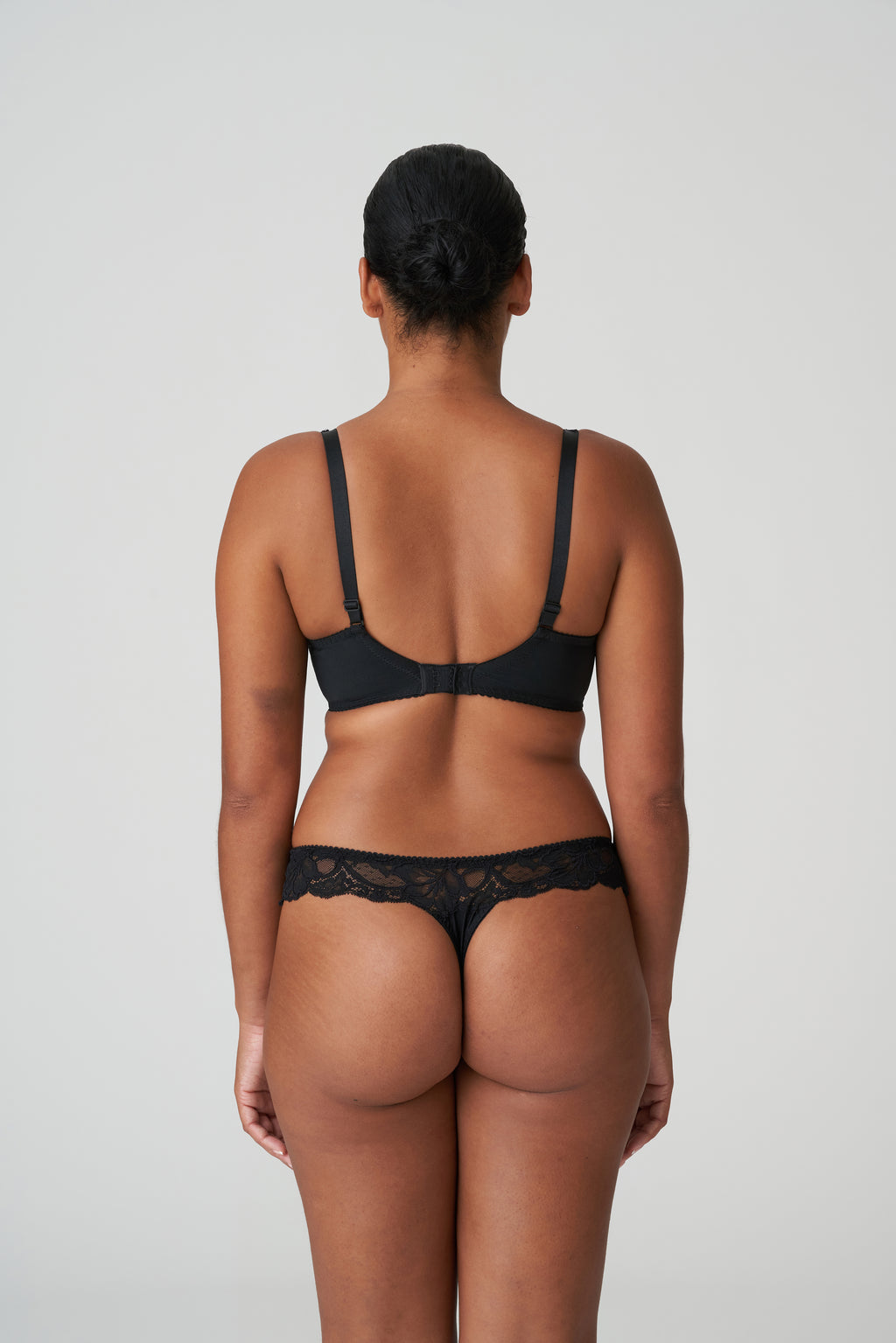 Primadonna Madison black G-string underwear with delicate lace details and minimal coverage, showcasing a sleek and stylish design.