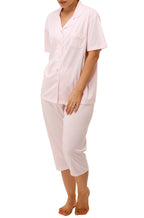 Pink polka dot pajama set by SHRANK with button-front top, breast pocket, and contrasting piping detail.