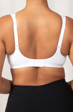 White Triaction sports bra by Triumph, featuring a supportive design and larger cup size options.