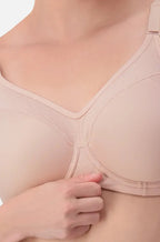 Triumph Triaction Sport Bra in nude, featuring supportive design and adjustable straps, displayed on a mannequin.