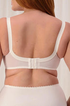Triumph Poesie Firm Support Wire-Free Bra in nude, size 20C, featuring adjustable straps and soft fabric.