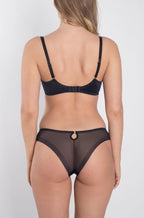 Black and nude semi-sheer thong with gold fittings by Samanta, available in sizes S, M, L.